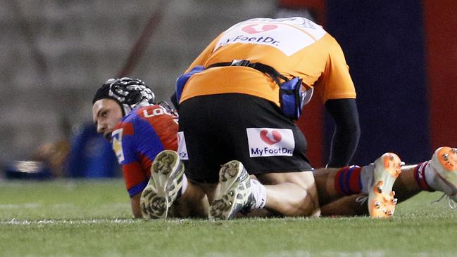 Kalyn Ponga of the Knights is treated for a hamstring tear during the Round 16 NRL match between the Newcastle Knights and the Canterbury-Bankstown Bulldogs at McDonald Jones Stadium in Newcastle, Saturday, June 30, 2018. (AAP Image/Darren Pateman) NO ARCHIVING, EDITORIAL USE ONLY