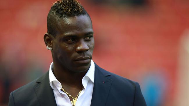 Liverpool's Mario Balotelli stands at the side of the pitch prior to the English Premier League soccer match between Liverpool and Stoke City at Anfield, Liverpool, England, Saturday Nov. 29, 2014. (AP Photo/PA, Peter Byrne) UNITED KINGDOM OUT NO SALES NO ARCHIVE