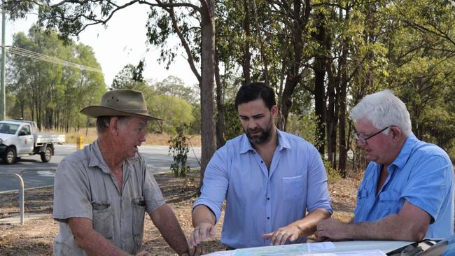 Gold Coast City Council Division One candidate Mark Hammel (standing in the middle) with locals Geoff Rossman and Dave Collard discussing the maps for the Coomera Connector.