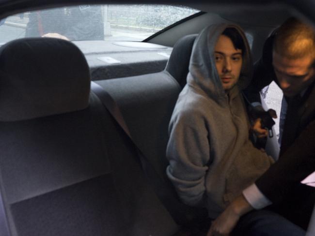 Arrested ... Martin Shkreli is belted into an awaiting car after being taken into custody following a securities probe.  Picture:  AP