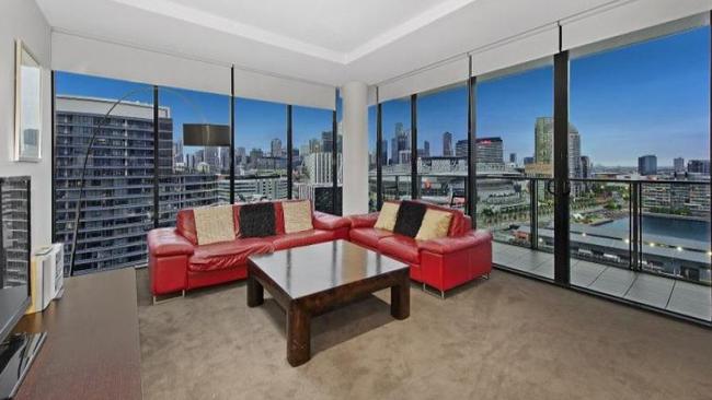 The living zone and balcony have a city backdrop at 1701/5 Caravel Lane, Docklands.