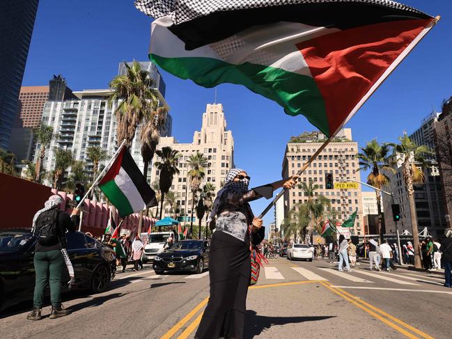 A protestor waves a Palestinian flag as people rally in support of Palestinians in Los Angeles, California on October 21, 2023, amid ongoing conflict between Israel and Hamas. (Photo by DAVID SWANSON / AFP)