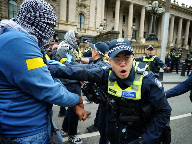 Police hold back protesters face as pro-Palestine and pro-Israel groups clash. Picture: Luis Enrique Ascui