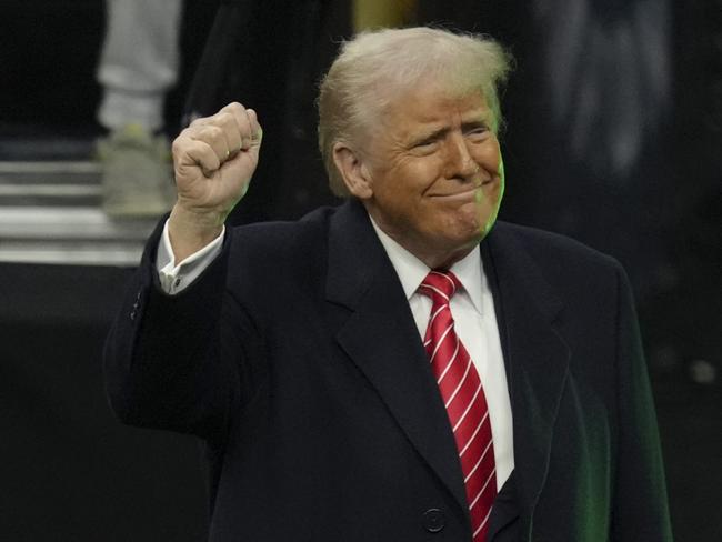 PHILADELPHIA, PENNSYLVANIA - MARCH 22: U.S. President Donald Trump salutes the crowd during the 2025 NCAA Division I Men's Wrestling Championship at the Wells Fargo Center on March 22, 2025 in Philadelphia, Pennsylvania. (Photo by Mitchell Leff/Getty Images)