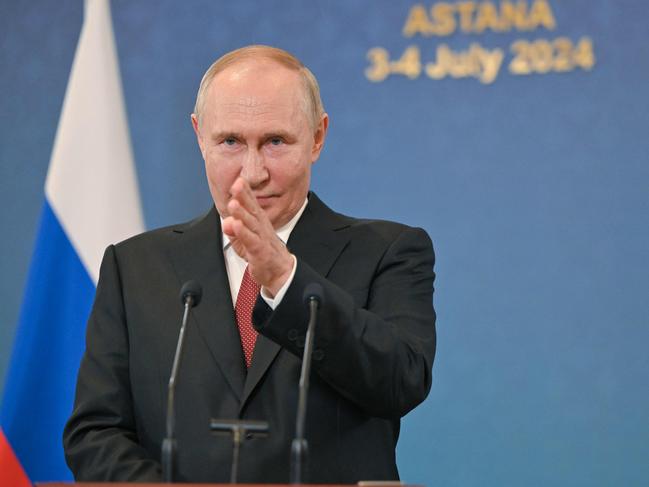 In this pool photograph distributed by the Russian state agency Sputnik, Russia's President Vladimir Putin meets with the Russian media after the Shanghai Cooperation Organisation (SCO) member states leaders' summit in Astana on July 4, 2024. (Photo by Sergei GUNEYEV / POOL / AFP)