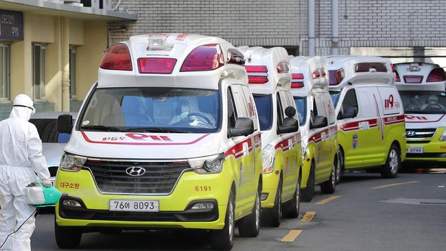 Ambulances carrying patients infected with the COVID-19 arrive at hospital during the first wave of the virus in South Korea. Picture: YONHAP/AFP