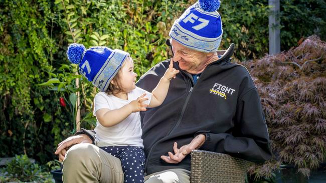 Neale Daniher and granddaughter Rosie, 18 months, try out this year’s Big Freeze beanies. Picture: Tim Carrafa