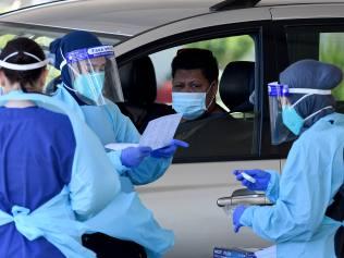 NSW Health workers dressed in Personal Protection Equipment (PPE) are seen performing COVID-19 tests at the SydPath drive through COVID-19 testing clinic in Merrylands, Sydney. Picture: NCA NewsWire/Bianca De Marchi