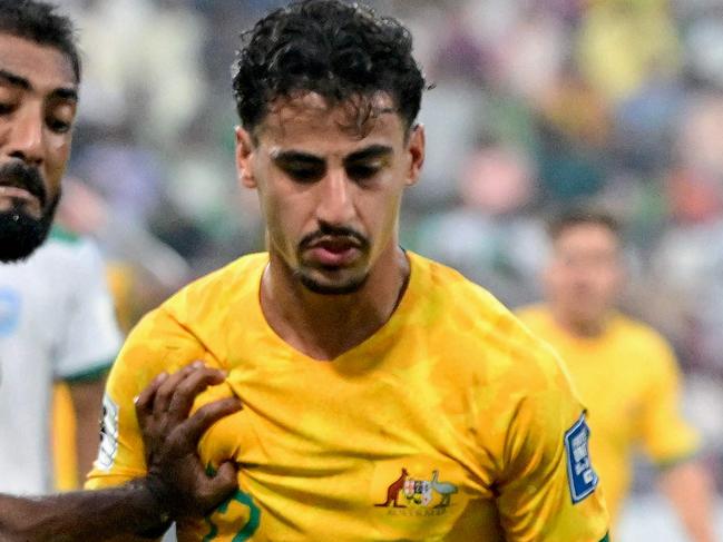 Australia's Daniel Arzani (R) fights for the ball with Bangladesh's Isa Faysal during the 2026 FIFA World Cup Asian qualification football match between Bangladesh and Australia at the Bashundhara Kings Arena in Dhaka on June 6, 2024. (Photo by MUNIR UZ ZAMAN / AFP)