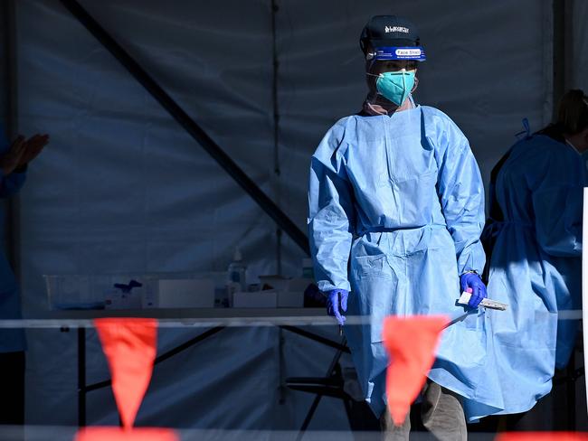 SYDNEY, AUSTRALIA - NewsWire Photos - JULY, 13, 2021: Health workers dressed in Personal Protection Equipment (PPE) wait to conduct COVID-19 tests at the new 24/7 Fairfield West Laverty Pathology Pop-up Drive-through clinic, in Sydney. New South Wales has recorded 89 new locally transmitted coronavirus cases overnight, 21 of which were infectious during their time in the community, with new testing orders for essential workers in Fairfield and Greater Sydney kicking in at 12.01am tomorrow. Picture: NCA NewsWire/Bianca De Marchi