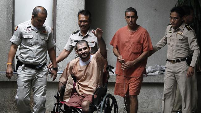 Thai prison officers escort Iranian Saeed Moradi, 29, (in wheelchair) and Mohammad Khazaei, 43, as they leave the Bangkok South Criminal Court August 22, 2013. Picture: Reuters