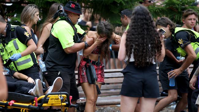 Two young girls are helped by specialist ambulance crews at Hardcore Till I Die. Picture: Damian Shaw