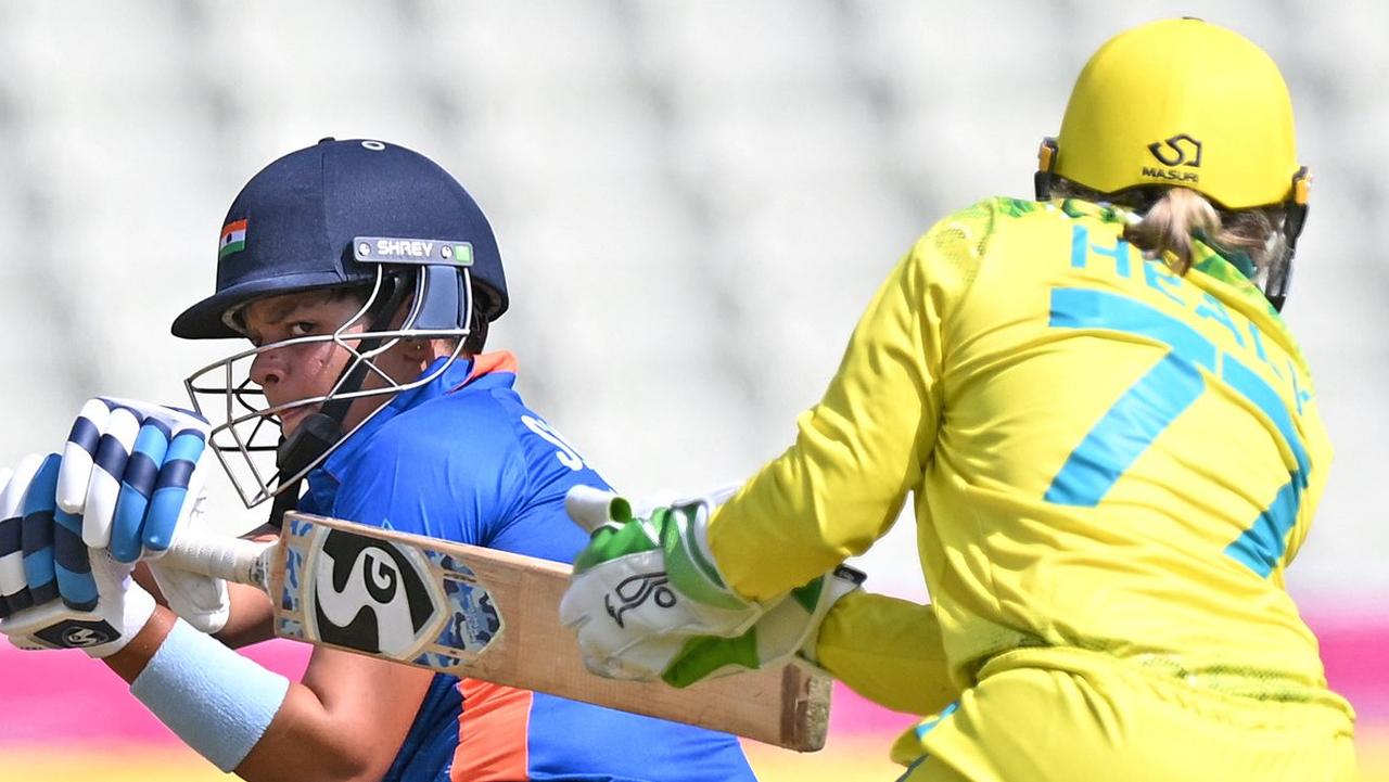 India's Shafali Verma (L) is caught behind by Australia's Alyssa Healy during the women's Twenty20 cricket match