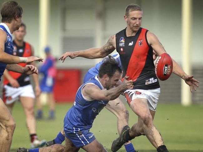 Adelaide Footy League division one game between St Peter's Old Collegians and Tea Tree Gully at St Peters. TT Gully's Jack Astbury tries to clear under pressure from St Peters Sam Stott. 11 May 2019. (AAP Image/Dean Martin)