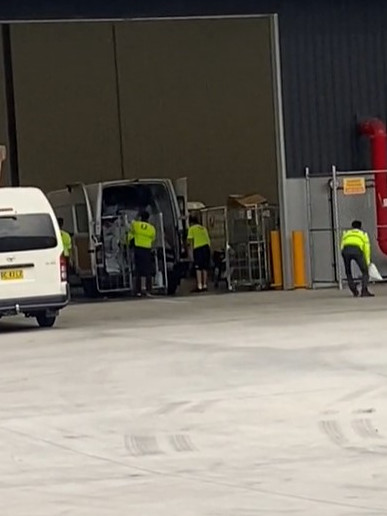 A group of Australia Post workers were seen throwing the parcels into a van. Picture: TikTok