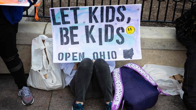 Protesters hold up signs outside of the Ohio State House in Columbus. Picture: AFP