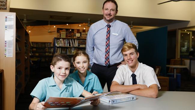 St Andrew's Catholic College at Redlynch is one of the best funded schools in Far North Queensland. St Andrew's Catholic College principal Ian Margetts with students Archer Wickerson, Lilly Hogan and Edward Hamilton in the school library. Picture: Brendan Radke