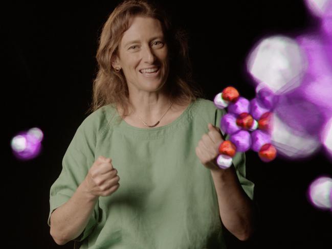 Astrophysicist Tamara Davis surrounded by animated molecules Global Mechanic/ Bruce Alcock