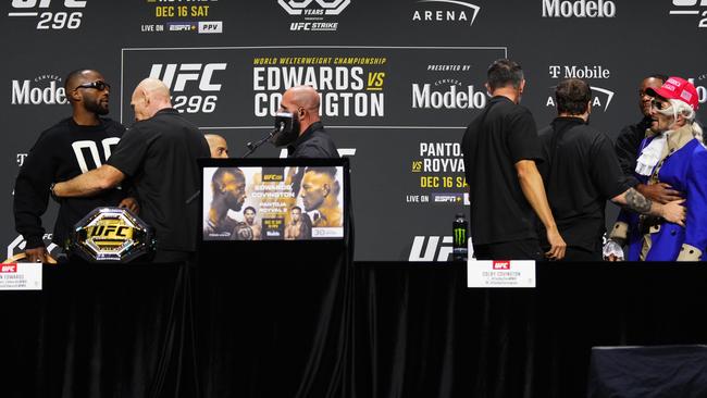 Leon Edwards (L) and Colby Covington (dressed as George Washington) are separated by security. Picture: Jeff Bottari/Zuffa LLC via Getty Images