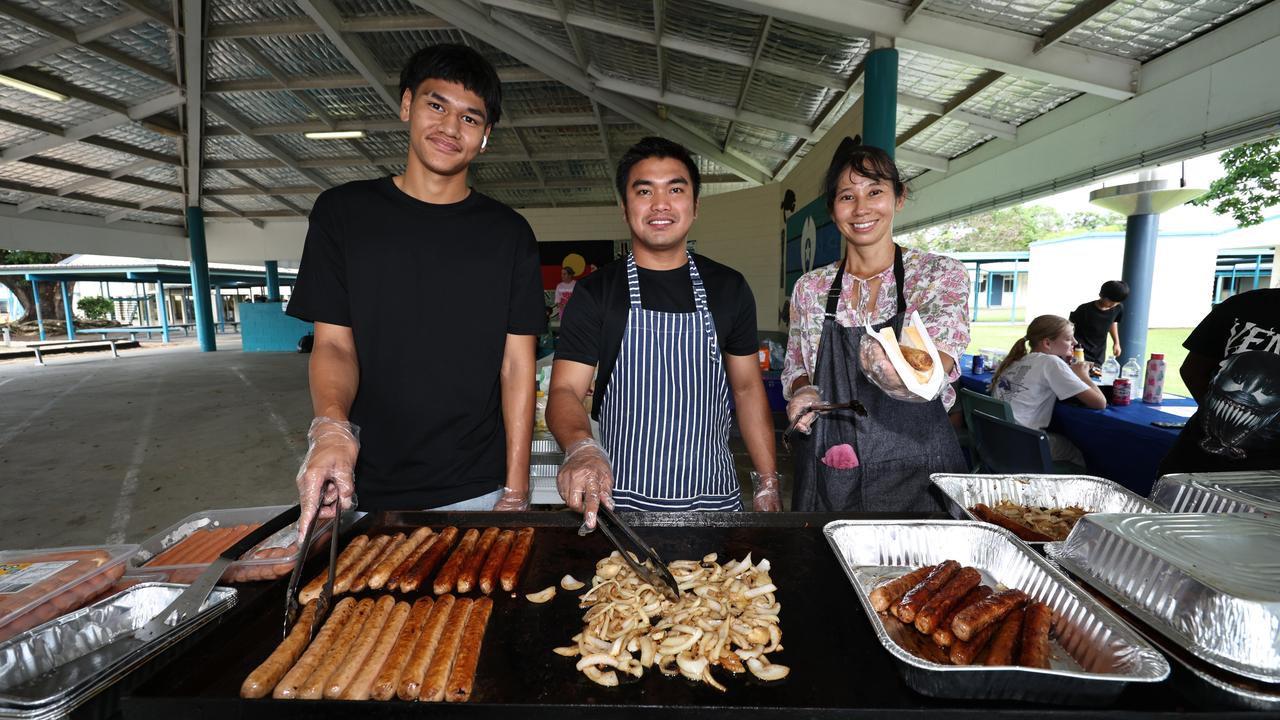 Former student Steven Tereni and parents of year 6 students, Adrian Basanez and Yuki Mipamura, take charge on the barbecue, serving up sausages to hungry voters at the Parramatta State School polling booth. Picture: Brendan Radke