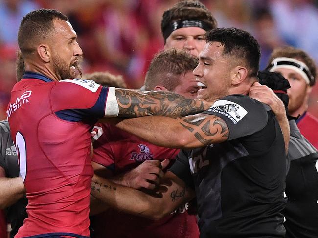 Reds player Quade Cooper (left) and Crusaders player Codie Taylor during an altercation during the 3rd round Super Rugby match between the Queensland Reds and the Canterbury Crusaders at Suncorp Stadium in Brisbane, Saturday, Mar. 11, 2017. (AAP Image/Dave Hunt) NO ARCHIVING, EDITORIAL USE ONLY