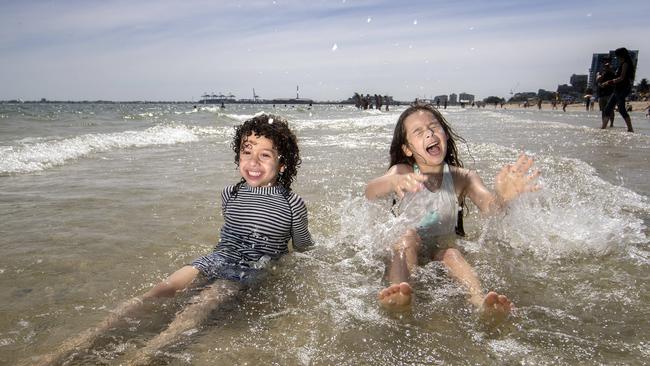 George Andrianopoulos, 4 and his sister Cleâ, 7 enjoying the warm summer weather at South Melbourne beach Picture: David Geraghty