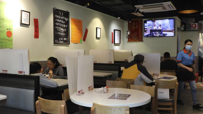 In Hong Kong and China, restaurants are required to keep the capacity below 50 per cent and restrict groups to a maximum of four people. Picture: Kin Cheung/AP