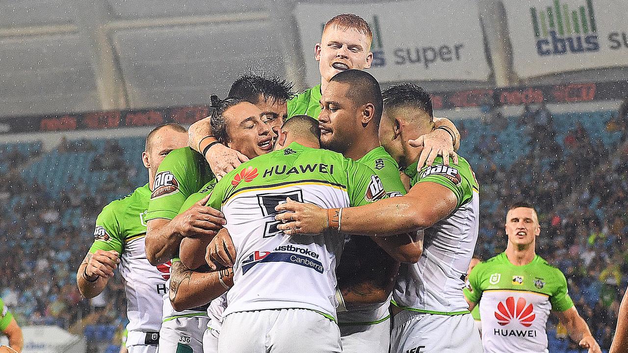 Joseph Leilua of the Raiders (centre) celebrates after scoring a try against the Titans.