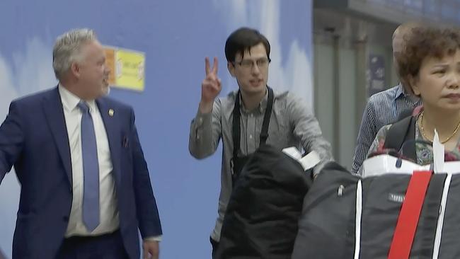 Australian student Alex Sigley gestures as he arrives at the airport in Beijing on Thursday, Picture: Emily Wang/AP