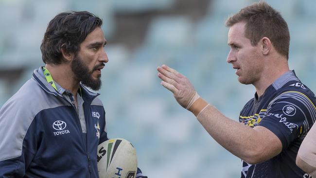 Johnathan Thurston of the Cowboys talks with Michael Morgan during a warm up.