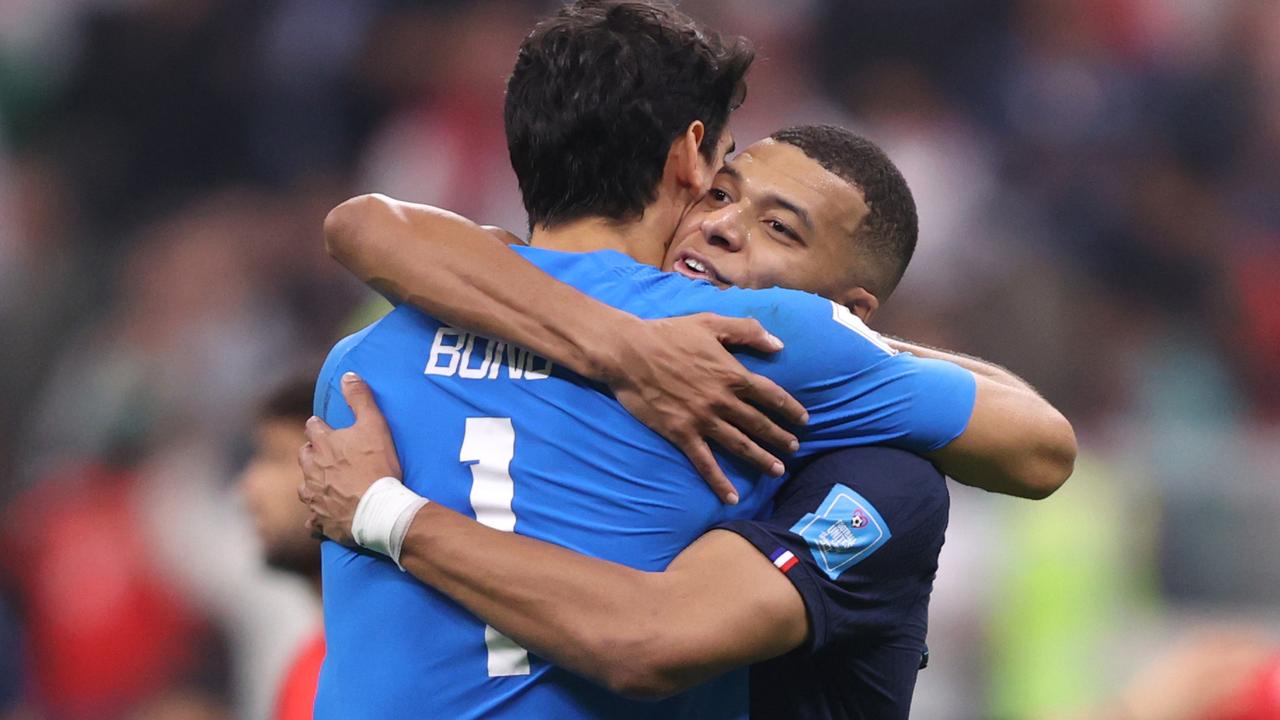 Kylian Mbappe of France embraces Yassine Bounou of Morocco after the FIFA World Cup semi final match.