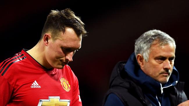 MANCHESTER, ENGLAND - SEPTEMBER 25:  Jose Mourinho, Manager of Manchester United applauds fans as Phil Jones of Manchester United looks dejected after missing his team's eighth penalty, meaning Derby County win the match on penalties during the Carabao Cup Third Round match between Manchester United and Derby County at Old Trafford on September 25, 2018 in Manchester, England.  (Photo by Gareth Copley/Getty Images)