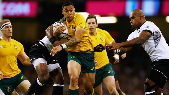 CARDIFF, WALES - SEPTEMBER 23: Israel Folau of Australia makes a break during the 2015 Rugby World Cup Pool A match between Australia and Fiji at the Millennium Stadium on September 23, 2015 in Cardiff, United Kingdom. (Photo by Laurence Griffiths/Getty Images)