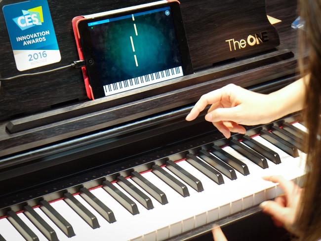 The One smart piano borrows from music video games like Rock Band and Guitar Hero to prompt the user’s keystroke. An accompanying iPad app provides a scrolling sheet of music. Photo: James Tindale/The Australian