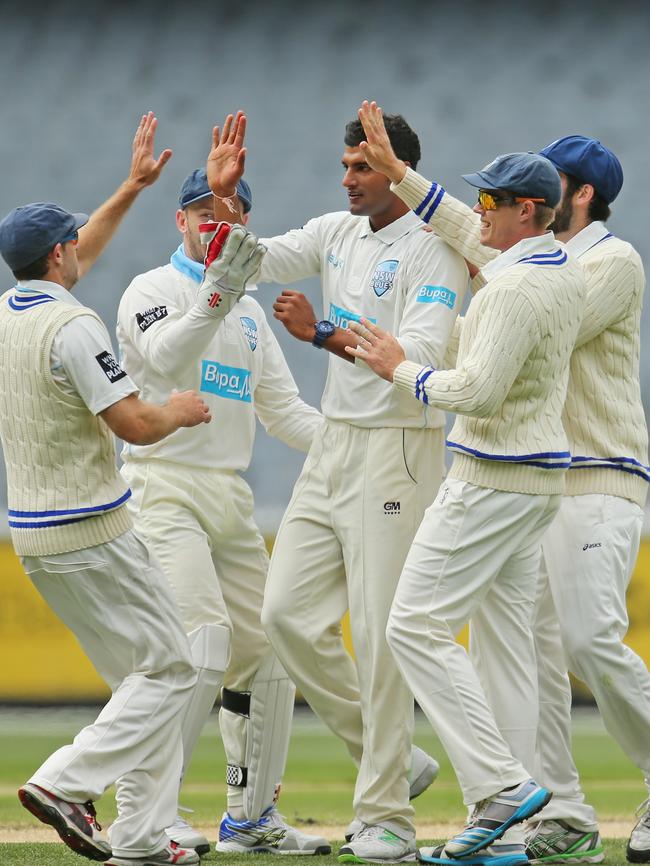 Sandhu is congratulated by his NSW teammates after dismissing David Hussey of Victoria during day three of the Sheffield Shield match against Victoria at the Melbourne Cricket Ground. Picture: Scott Barbour/Getty Images.