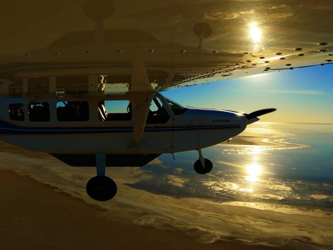 Charles Wooley flies over Lake Eyre to witness the rare sight of the lake filling up which only occurs once every 20 years. Picture: Arron Hage