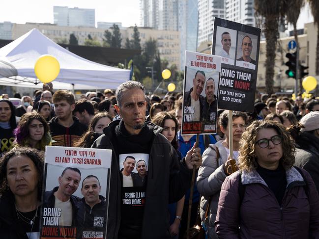 People hold photos of hostages in Gaza during a rally to mark 100 days that the hostages have been held in captivity on January 14. Picture: Amir Levy/Getty Images