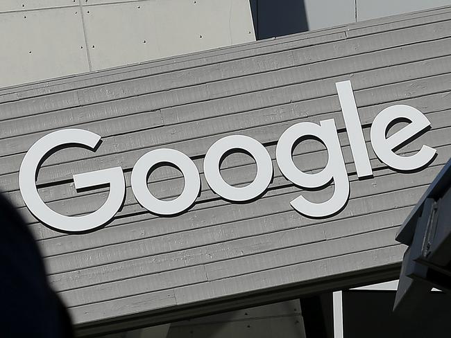 FILE - In this Nov. 12, 2015, file photo, a man walks past a building on the Google campus in Mountain View, Calif. Alphabet Inc., Google's holding company, reports financial results Monday, Feb. 1, 2016. (AP Photo/Jeff Chiu, File)