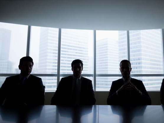 Silhouette row of businessmen sitting in meeting roomMen boardroom business company directors