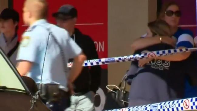 Barmaid Brooklyn Rankmore is comforted by her mother outside the Regents Park Hotel. Picture: Nine News