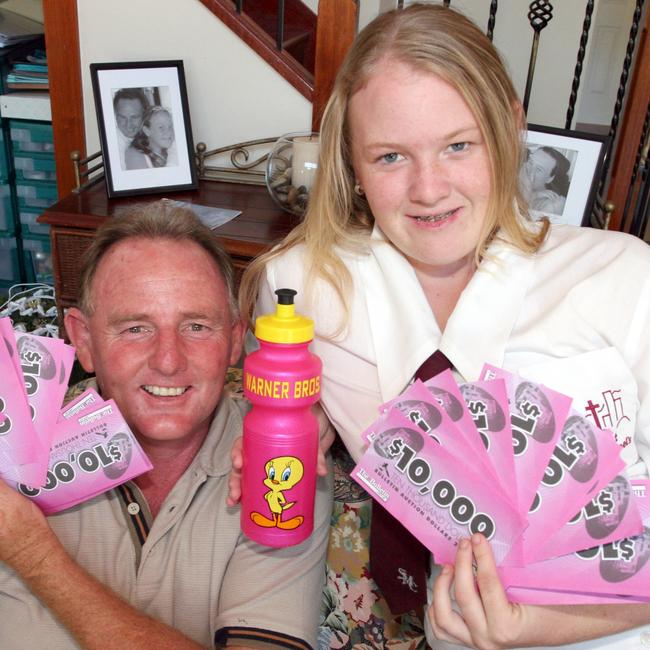 Mark Fitzpatrick and his daughter Kate with this year's Gold Coast Bulletin Auction Dollars. They won Movie World tickets.