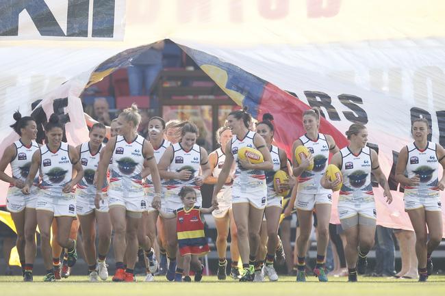 The Adelaide Crows players run out during the round 7 AFLW match against the Demons at Casey Fields in Melbourne. 