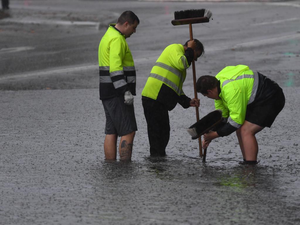 Council workers clear a drain on Railway Terrace in Lewisham during wild weather in Sydney, Wednesday, November 28, 2018. Sydney received more than a month’s worth of rain in just two hours - with Observatory Hill recording 84.6mm by 7am. The November average is 83.8mm. Picture: AAP Image/Dean Lewins