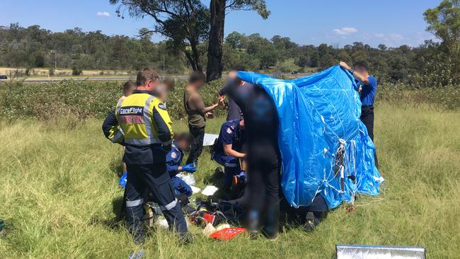 Bystanders and paramedics on scene at Wilton. Picture: Care Flight