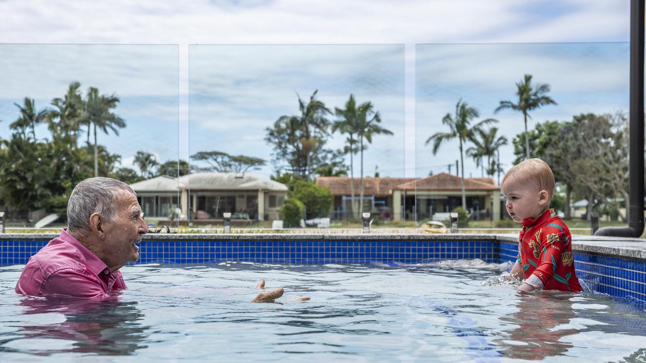 Laurie Lawrence and his grandchild in the pool. Picture: Mark Cranitch