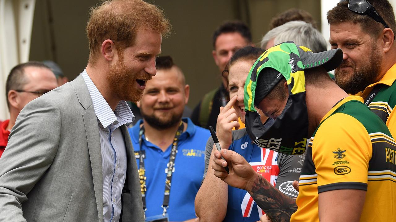 Prince Harry reacts as an Australian athlete asks for an autograph on a pair of trunks at the Invictus Games in Sydney in October 2018. Picture: Saeed KHAN / AFP.