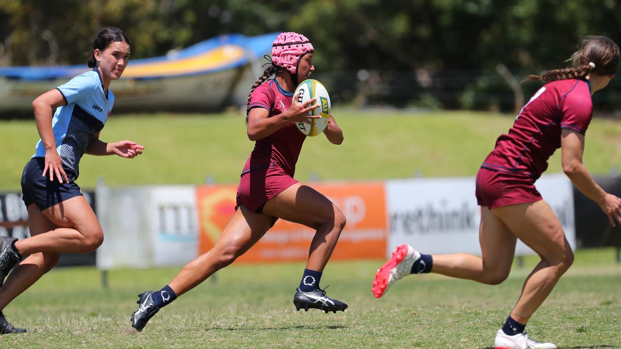 Amahli - Sieli Hala runs the ball during an event in Sydney.