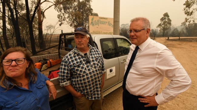Then-prime minister Scott Morrison (right) speaks with residents in Sarsfield, Victoria, Australia during the Black Summer Bushfires. Mr Morrison was heavily criticised for travelling to Hawaii during the natural disaster. Picture: Getty Images.