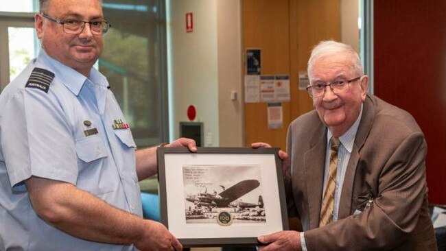 Angus Hughes was given an image of the iconic 467 Squadron Lancaster and a 100 Squadron coin to celebrate his 100th birthday, presented by Australian Defence Force Group Captain Greg Weller.