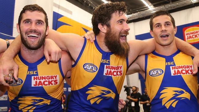 Jack Darling, Josh Kennedy and Liam Duggan are all smiles while singing the club song after the big win. Picture: Getty Images